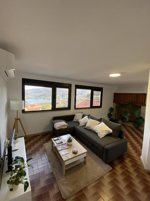 a living room with a couch and a coffee table at Casa Rodrigues in Terras de Bouro