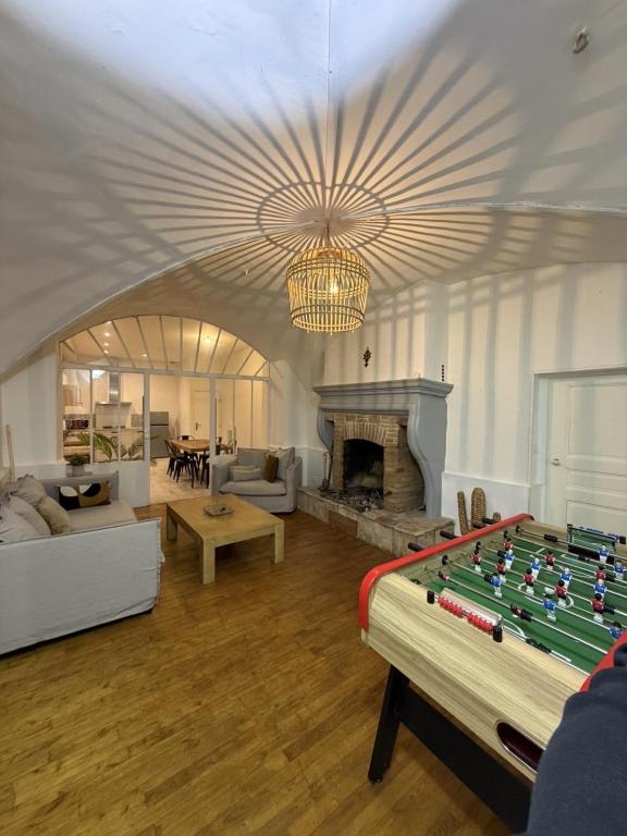 a living room with a pool table and a fireplace at Les remparts in Chabeuil