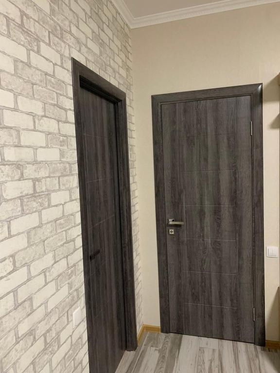 a door in a room with a brick wall at Апартамент студия in Khmelnytskyi