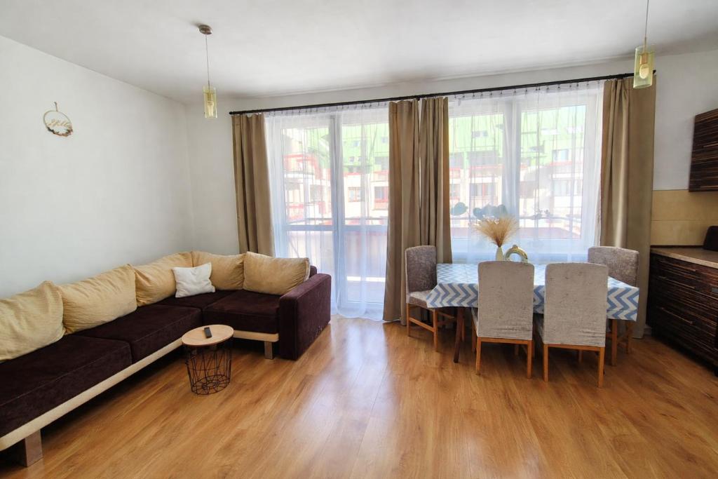 a living room with a couch and a table at Serce Suwałk in Suwałki