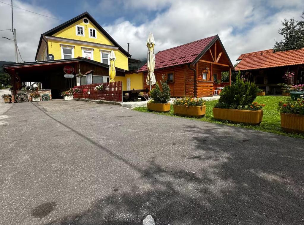 a house with a driveway in front of a building at Sošice Garden Apartments in Sošice