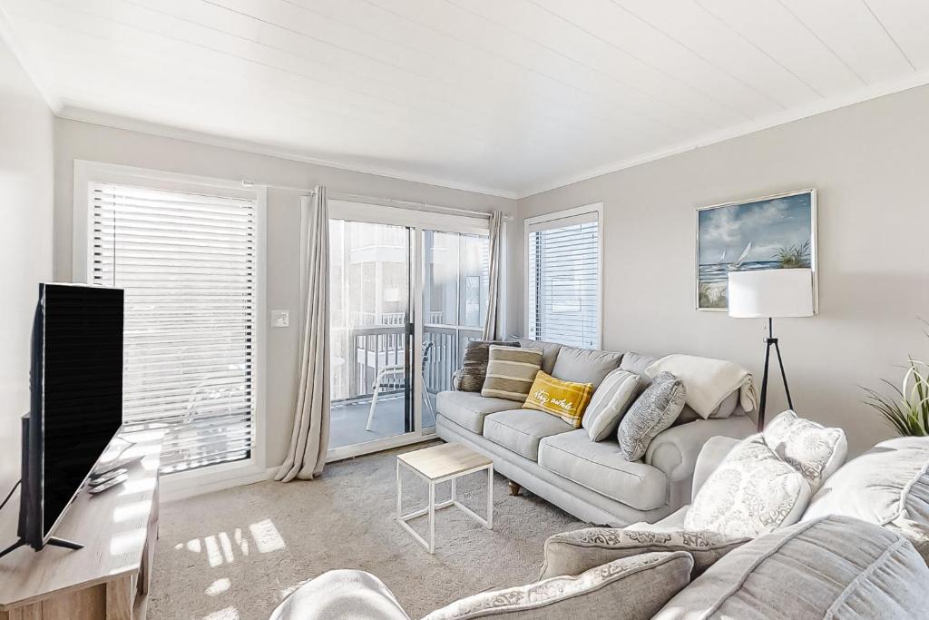 a living room with a couch and a tv at ABDV22 Dunescape Villas 236 in Atlantic Beach