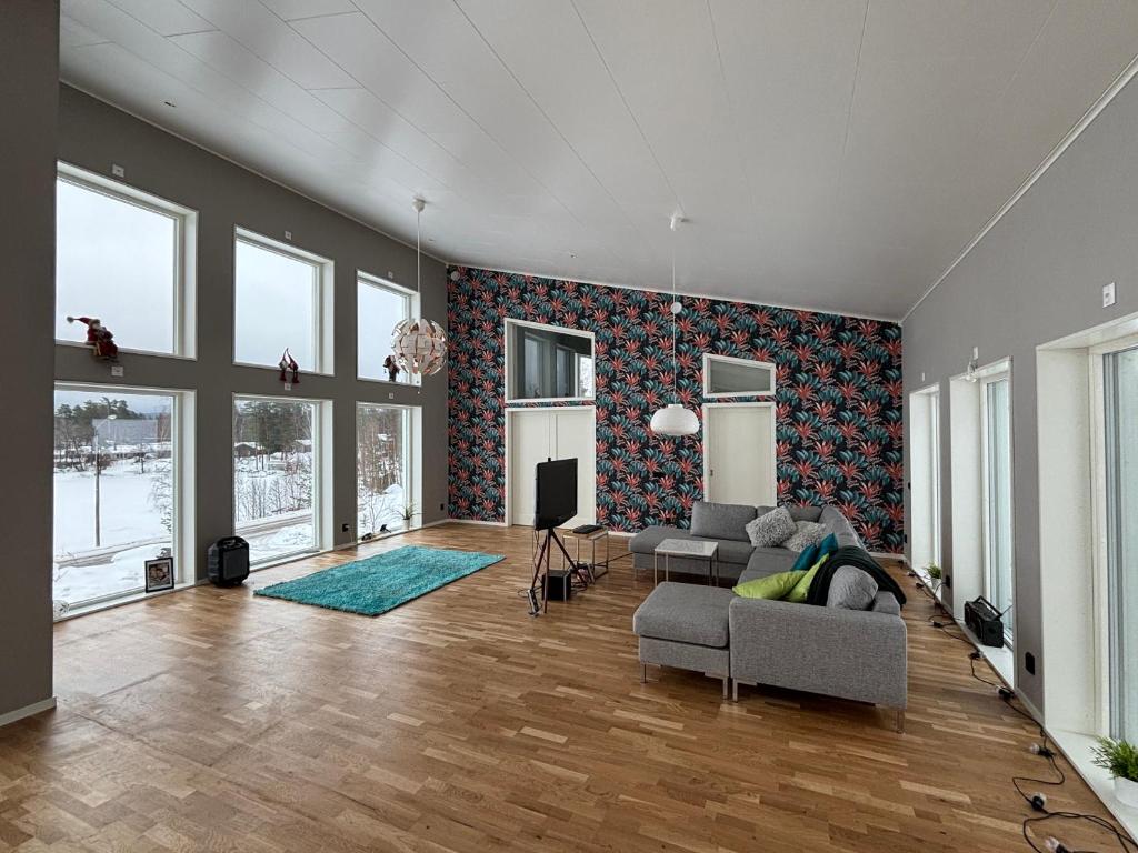 a living room with a couch and a tv at Lake View Villa in Falun