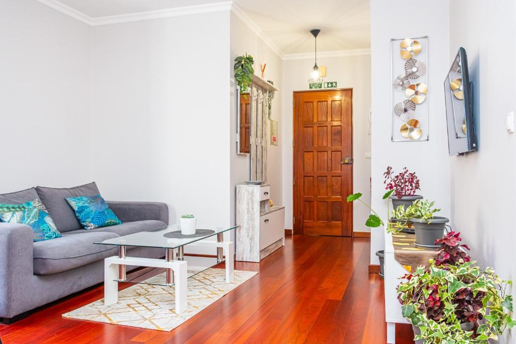 a living room with a couch and a table at StayinMachico in Machico