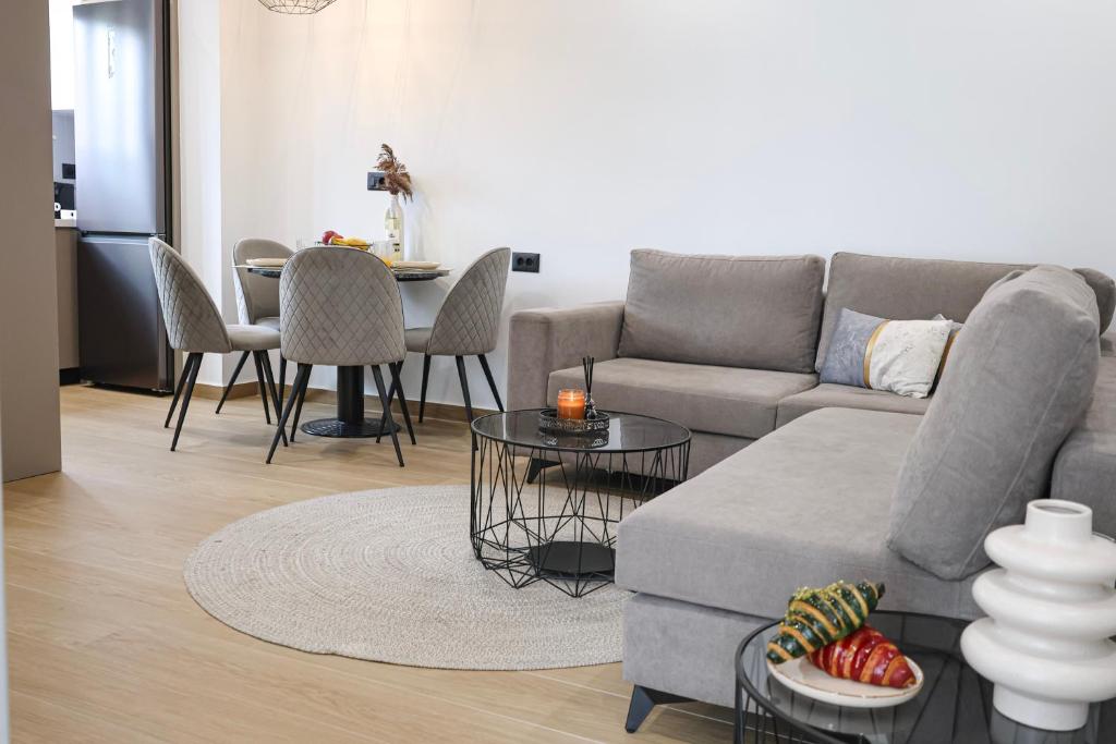a living room with a couch and a table at Xenia Residence in Faliraki