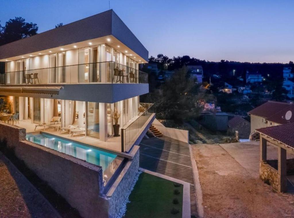 a large house with a swimming pool in front of it at Villa La Bella Vista in Basina