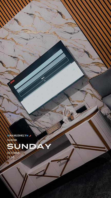 a book sitting on top of a marble counter top at Shiela inn in Nairobi