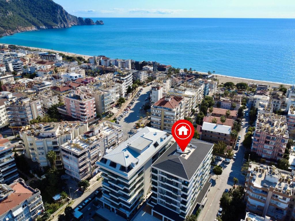 a city with a red sign on top of a building at SA Apartments! 150m to the Cleopatra Beach in Alanya