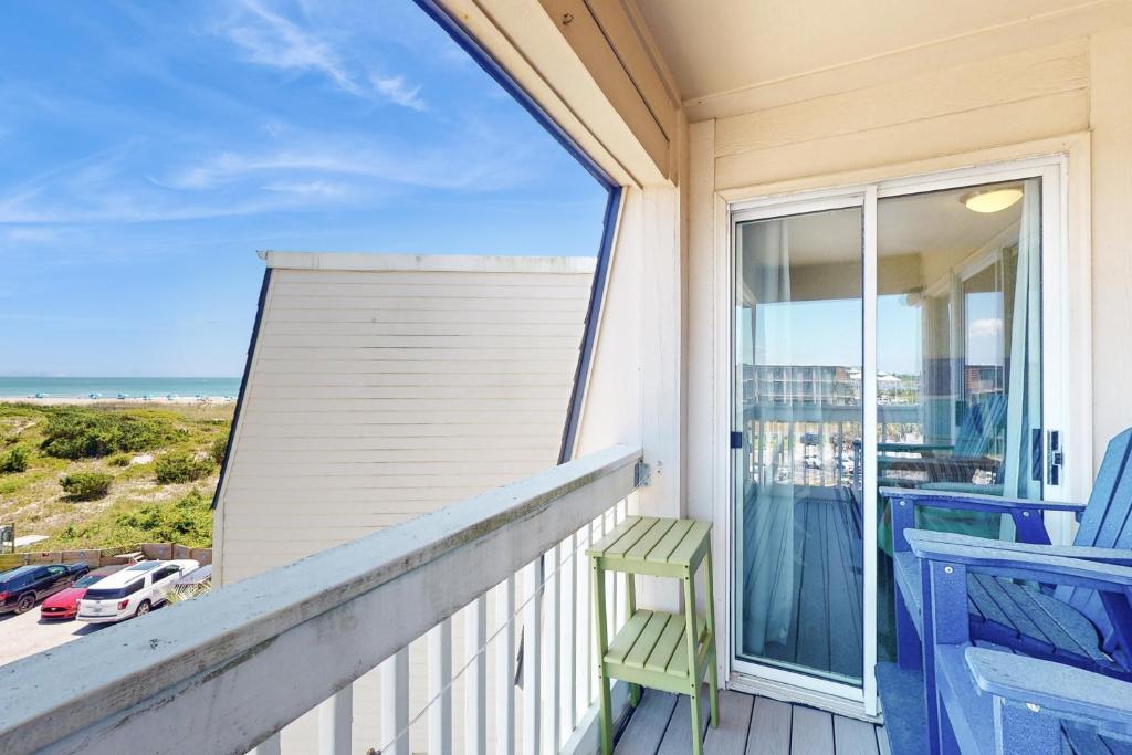 a balcony with a chair and a view of the ocean at ABPAB167 Blue Haven Beach Retreat in Atlantic Beach