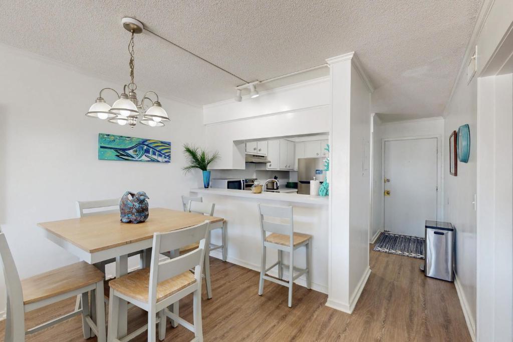 a kitchen and dining room with a table and chairs at ABPAB166 Sandy Shores in Atlantic Beach