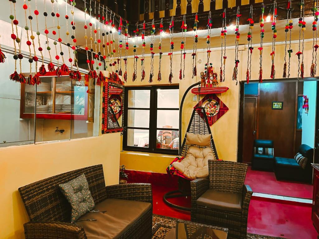 a living room with a couch and chairs and christmas decorations at Ñusta Wasi in Cusco