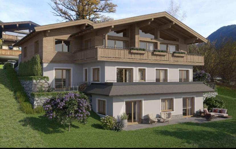 a large house with a balcony on top of it at Apartment Kirchfeld in Aurach bei Kitzbuhel
