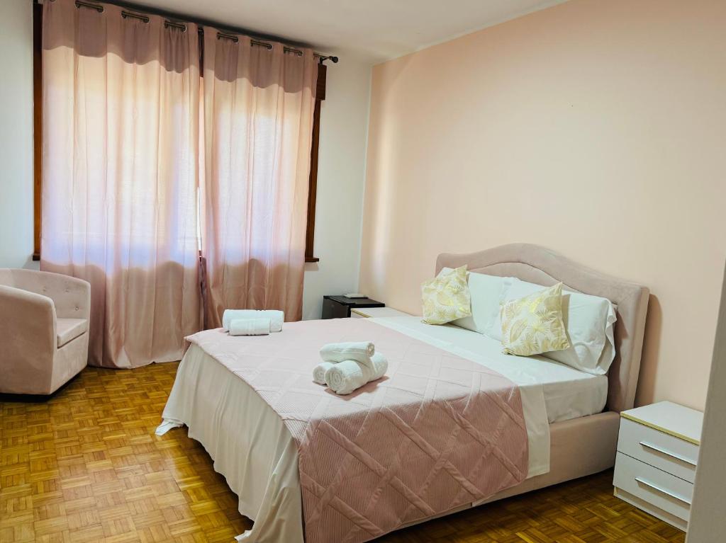 a bedroom with a bed with a teddy bear on it at First Dream Mestre in Mestre