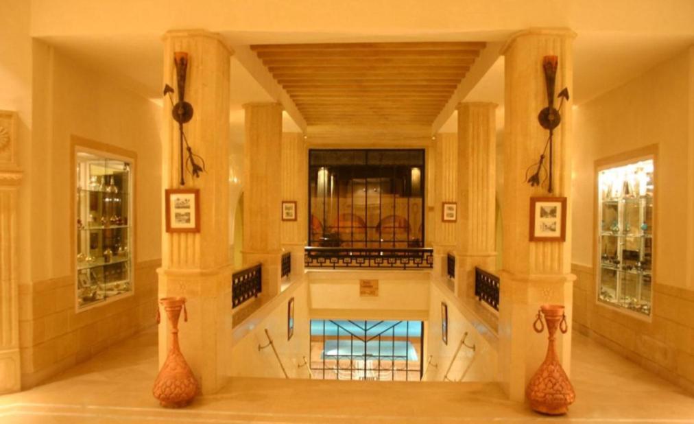 a large lobby with a pool in the center of a building at Ksar El Jerid in Tozeur