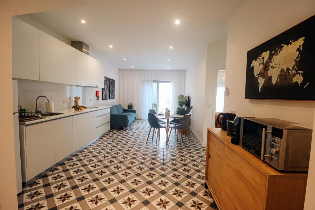 a kitchen and living room with a table and chairs at Peace In Azores in Pico da Pedra