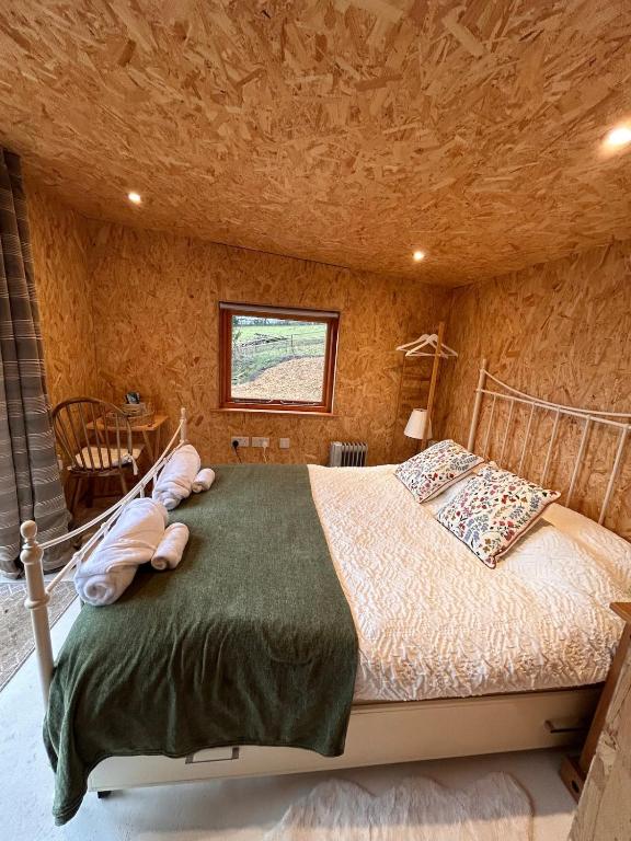 a bedroom with a large bed in a room at Bijou Cabin in Ludlow