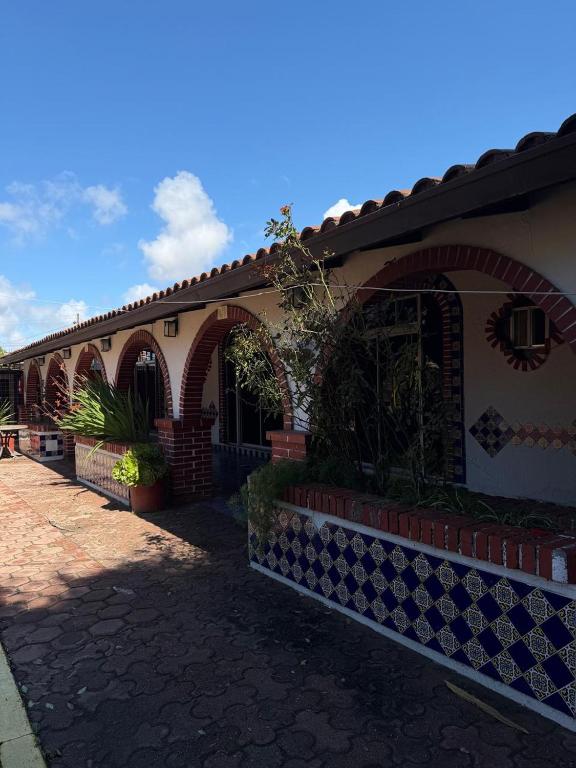 a house with an arched entryway and a brick building at Hacienda Rosarito in Rosarito Beach
