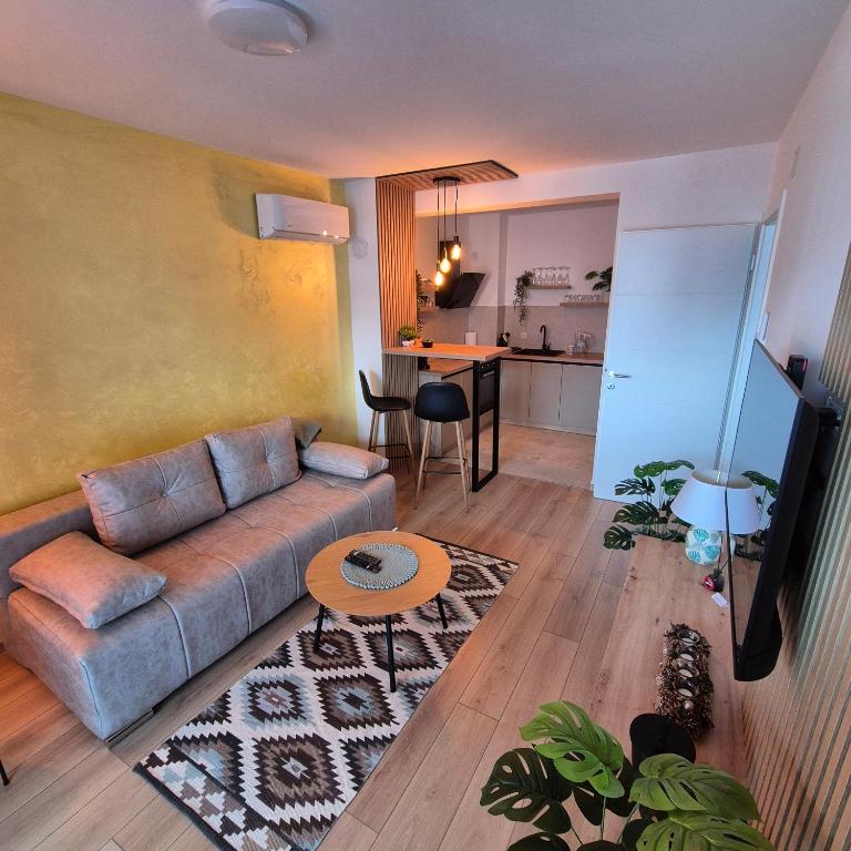 a living room with a couch and a table at Aura Apartment FREE PARKING in Brčko