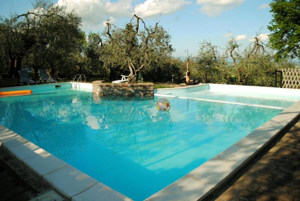 a swimming pool with a person in the water at Corolle2 in Montepulciano