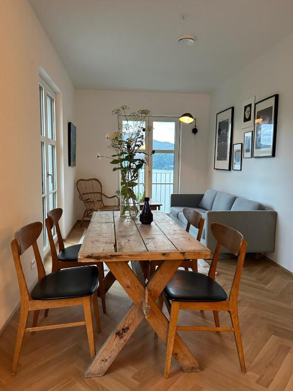 a dining room with a wooden table and chairs at Seaside apartment in Volda