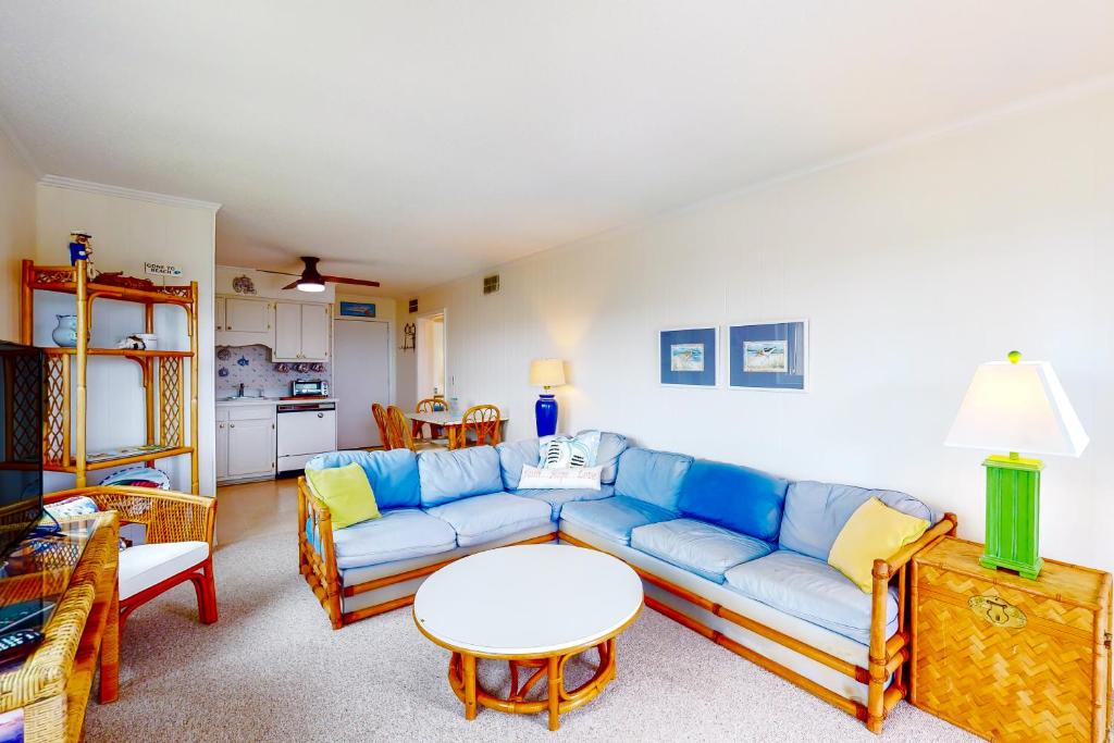 a living room with a blue couch and a table at ABSW163 Southwinds H13 in Atlantic Beach