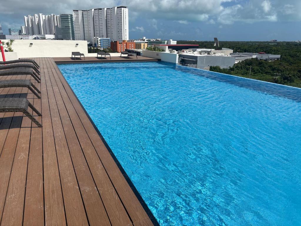 a large blue swimming pool on top of a building at San Francisco Cancun in Cancún
