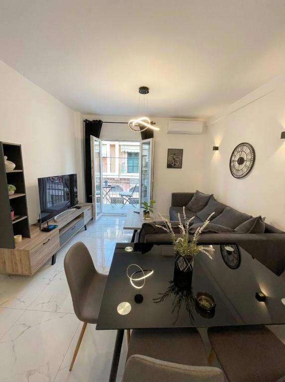 a living room with a couch and a table at White Port Suite in Ágios Rókkos