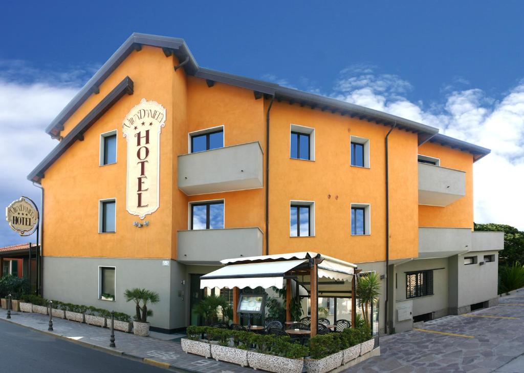 an orange building with a sign on the side of it at New Automatic Villa Daniela in San Bartolomeo al Mare