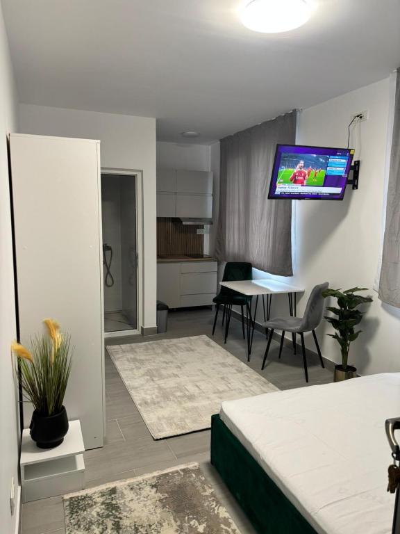 a living room with a couch and a tv on the wall at EriSSSo House Murfatlar in Murfatlar