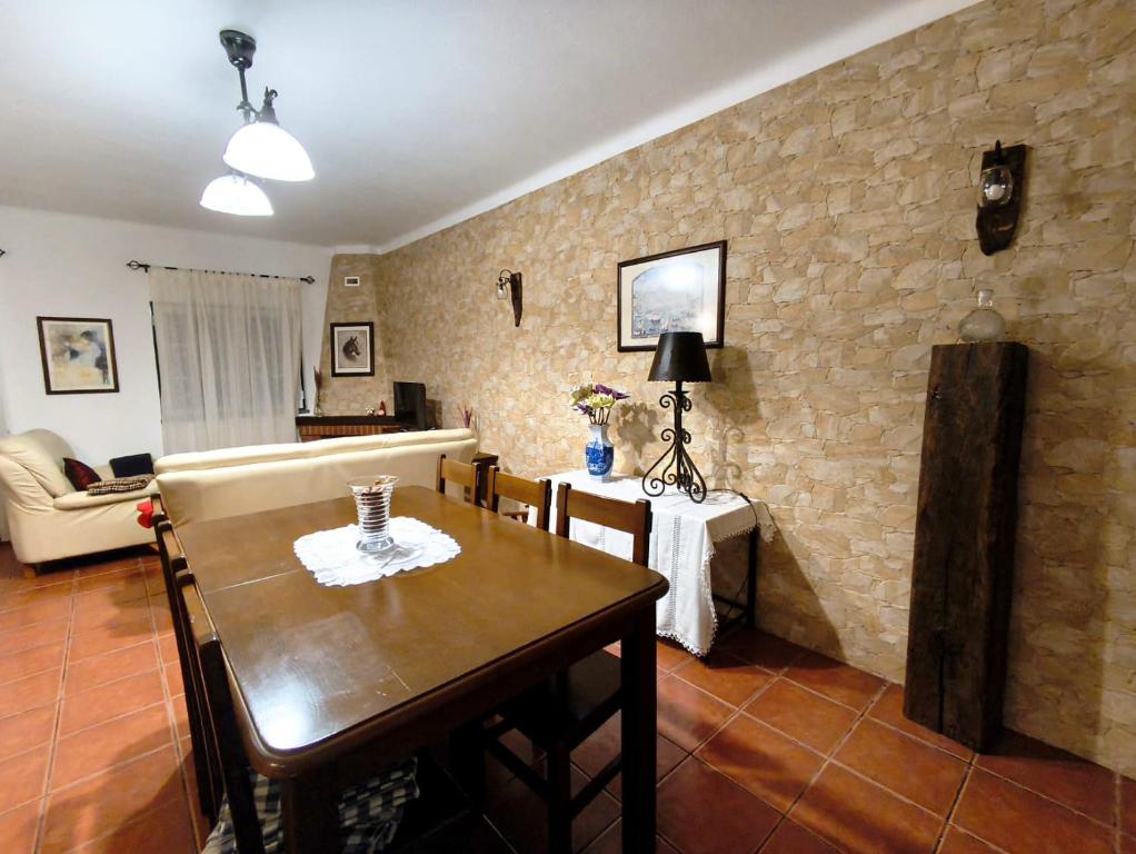 a living room with a wooden table and a couch at Casa D Dinis by NaturAlegre in Alegrete