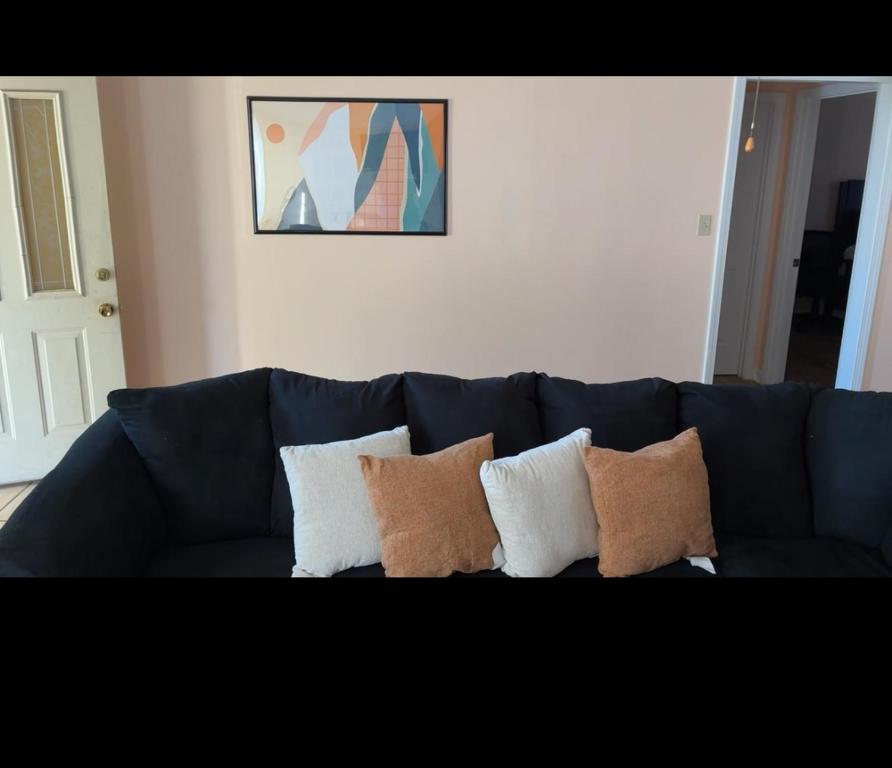 a blue couch with pillows on it in a living room at The Relaxing Home in Memphis