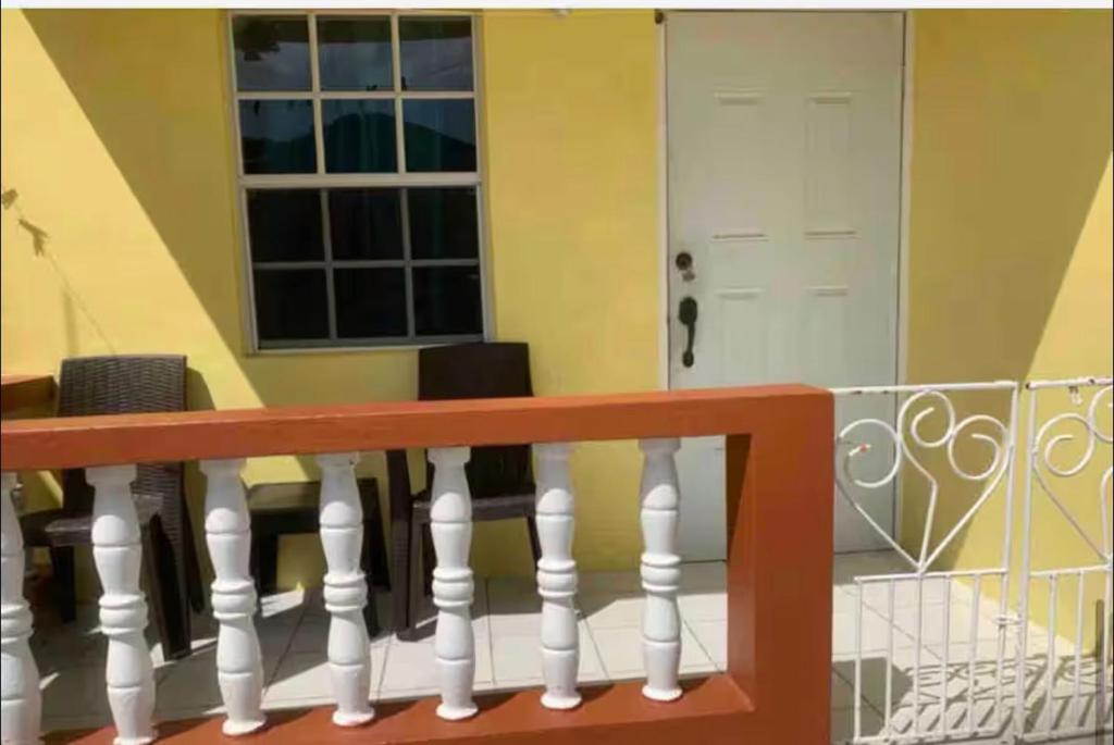 a balcony with a white railing and a white door at Duncan Apartment #1 in Port Elizabeth