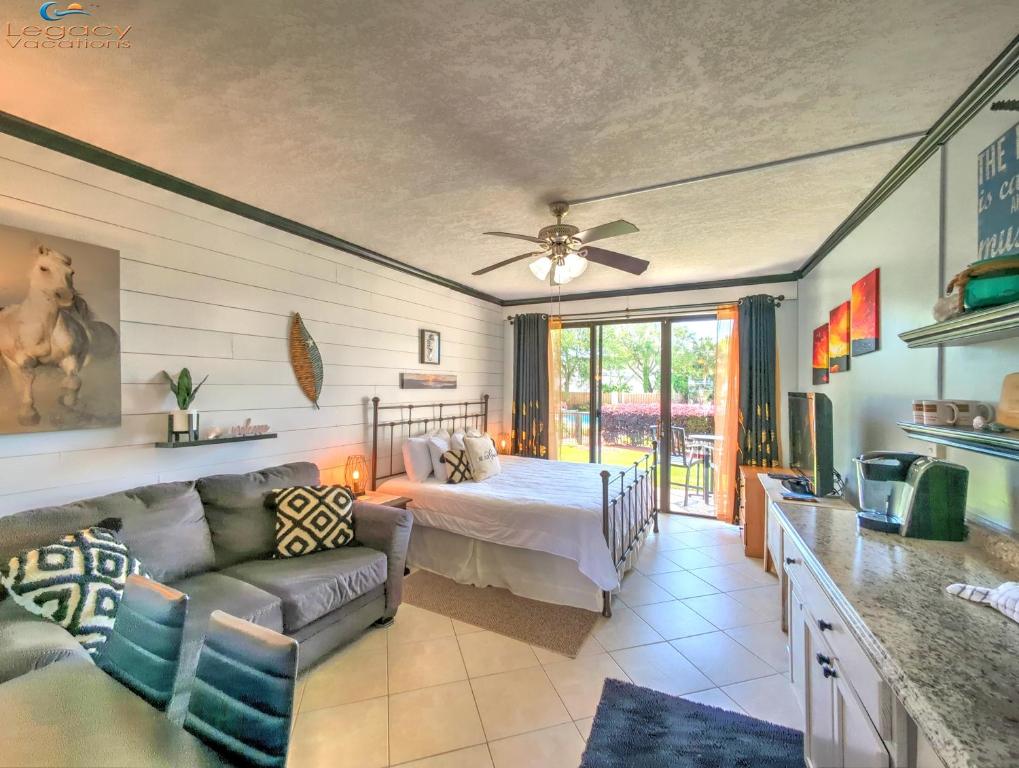 a living room with a bed and a couch at Pirates Bay B114 in Fort Walton Beach