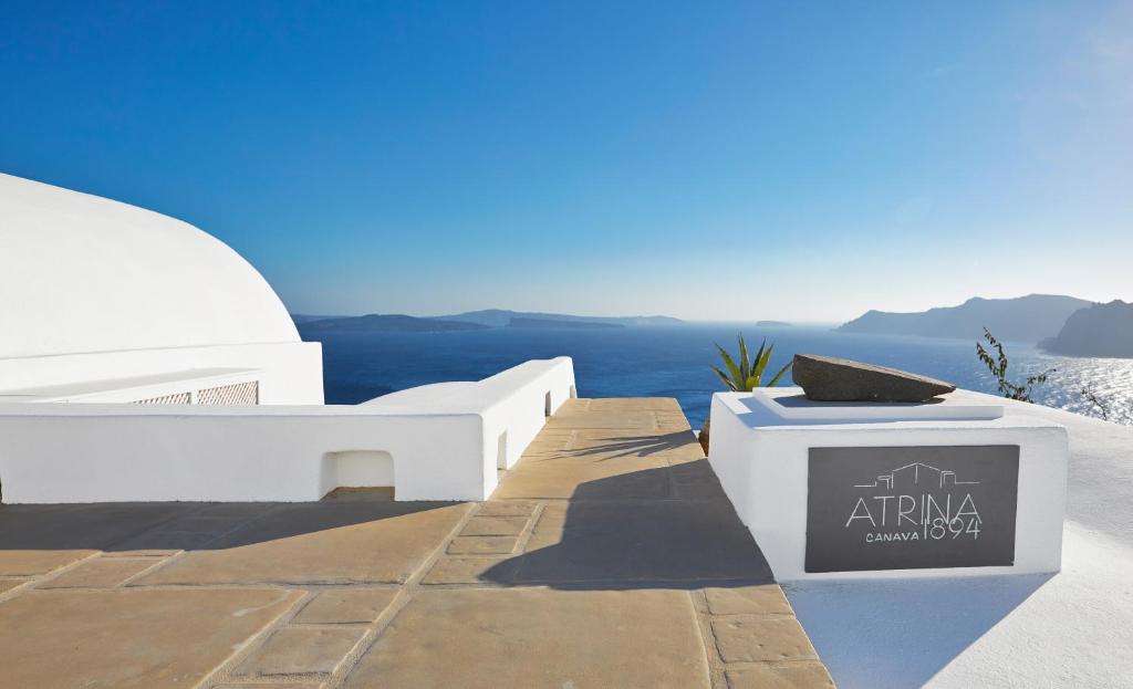 a view of the blue ocean from a white building at Atrina Canava 1894 in Oia