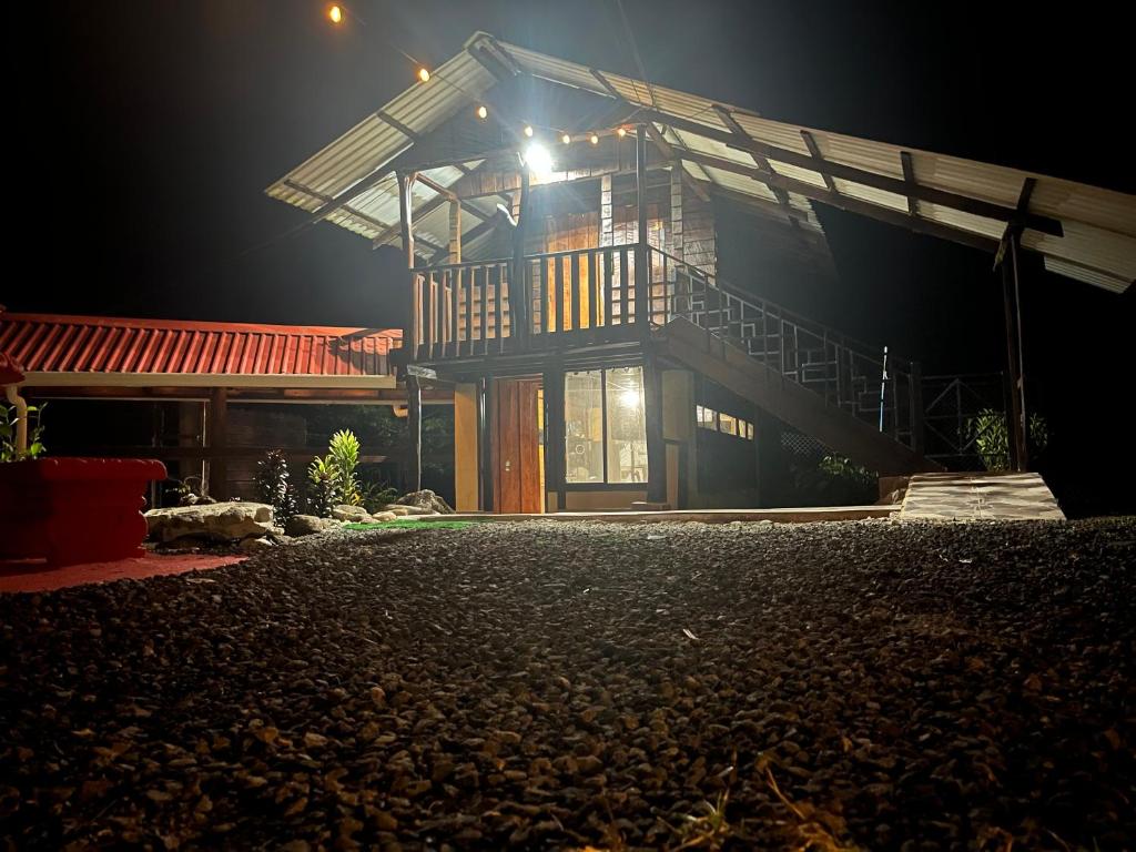 a house lit up at night with a light at Aire Agua y Naturaleza in Guácimo