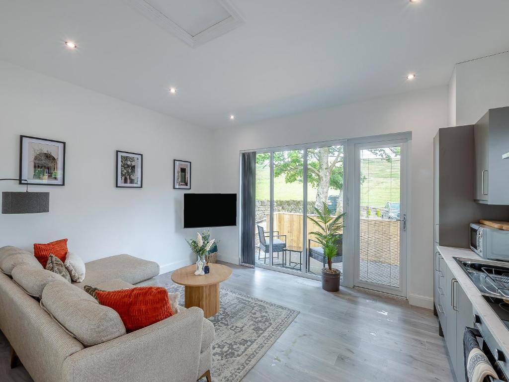 a living room with a couch and a table at Trig View - Uk49915 in Bardon Mill