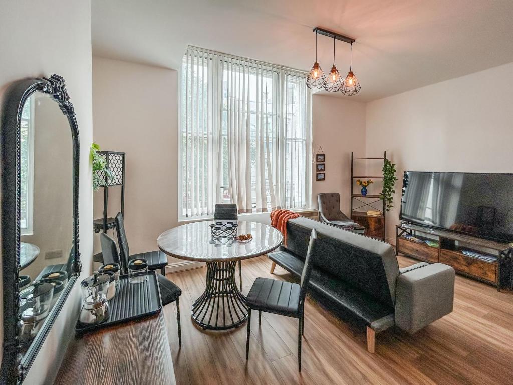 a living room with a couch and a table at Flat One in Weymouth
