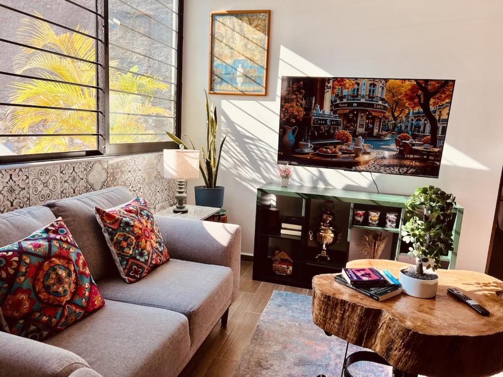 a living room with a couch and a table at Private Patio, Peaceful and Centric in Cedro