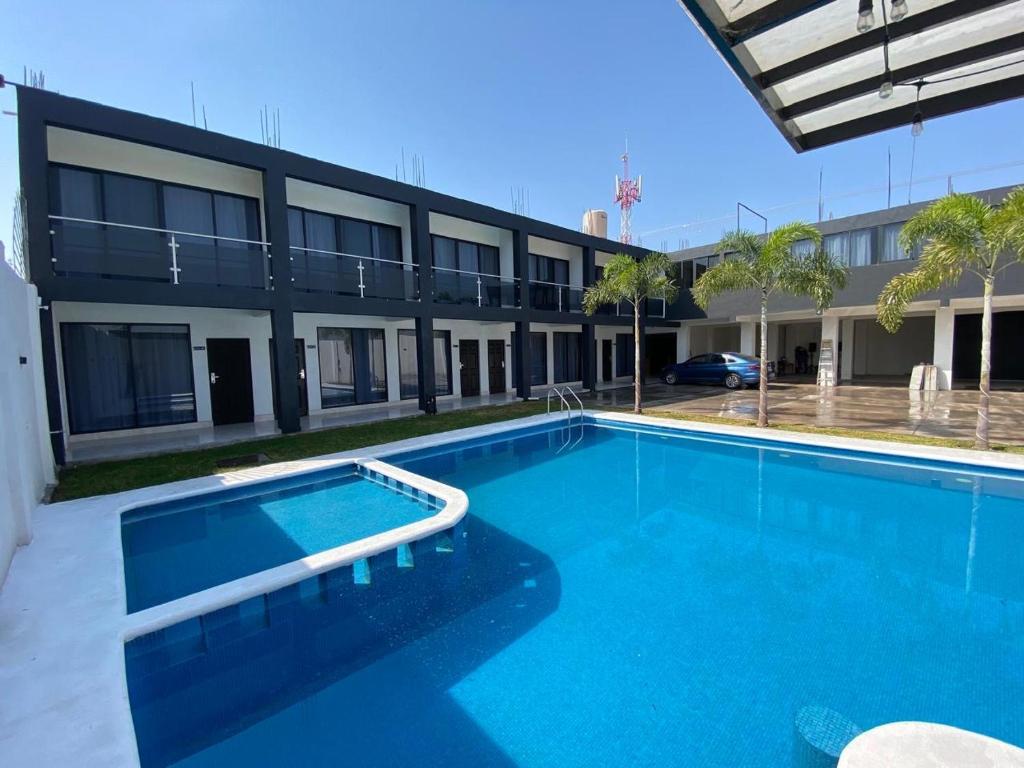 a large swimming pool in front of a building at Oasis Hotel Jojutla in Vallespin