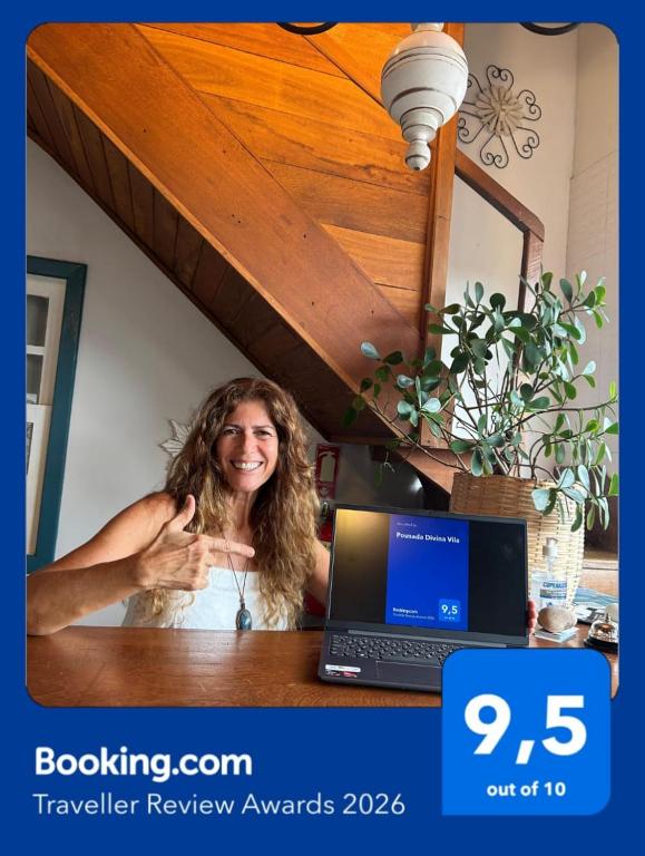 a woman sitting at a desk with a laptop computer at Pousada Divina Vila in Ilha de Boipeba