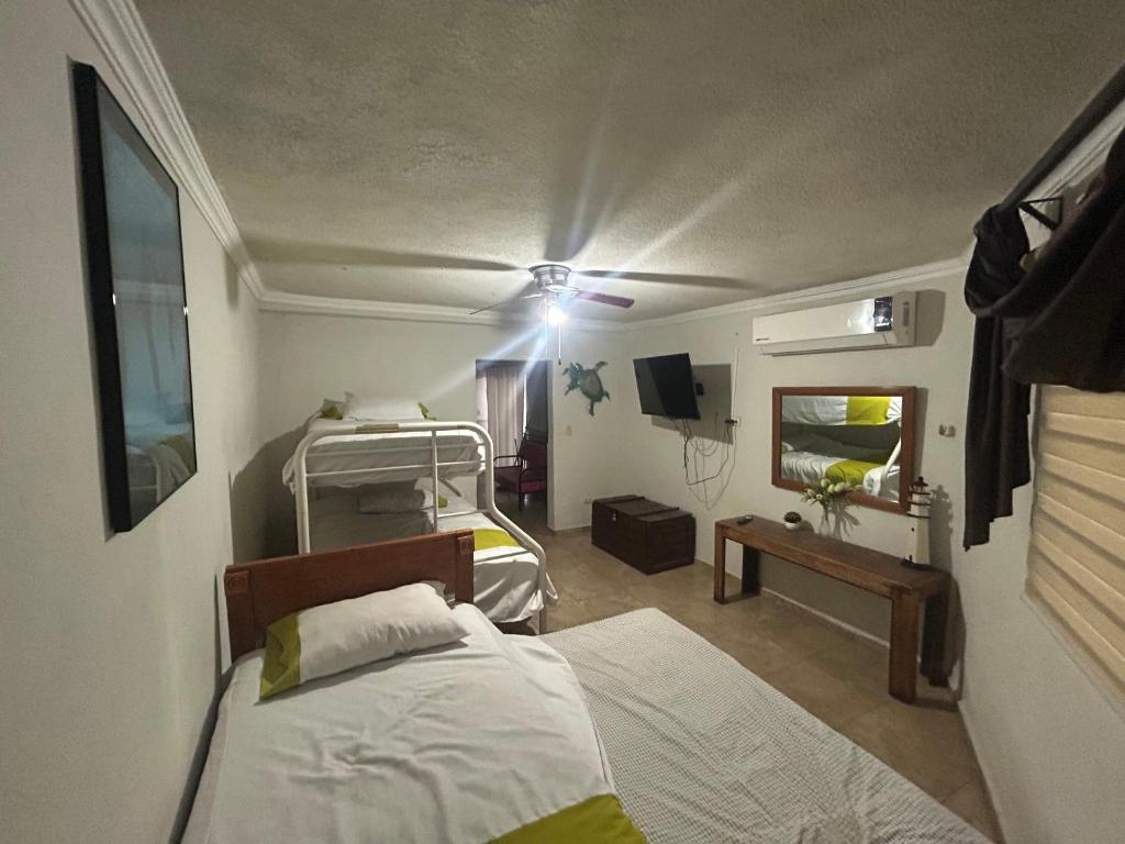 a hospital room with two beds and a tv at Departamento 1 tecalai San Carlos, Sonora, México in Rancho El Pozo