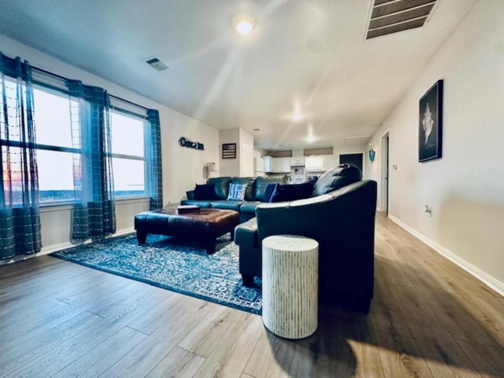 a living room with a couch and a table at Pelican Pointe Home for 10 in Bolivar Peninsula