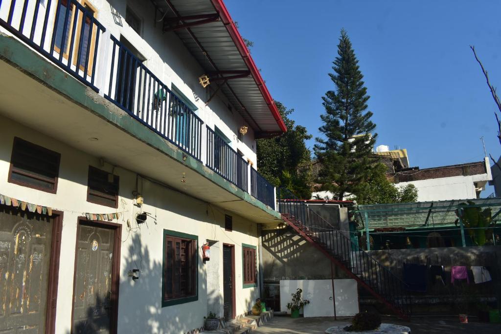 a building with a staircase on the side of it at vishranti homestayy in Rishīkesh