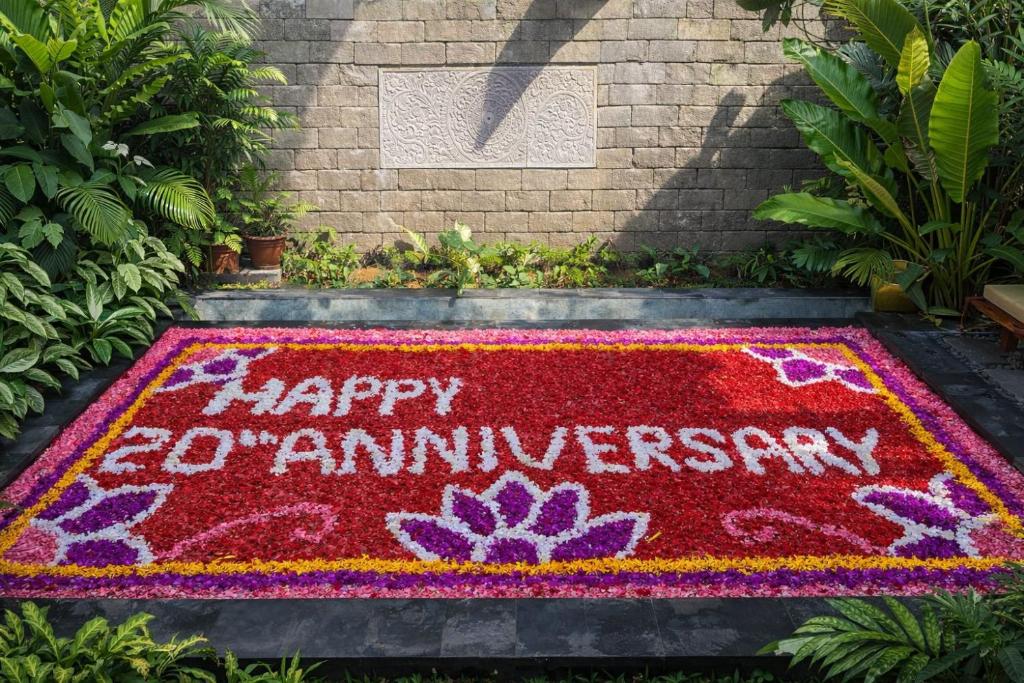 a happy red anniversary rug with flowers on a sidewalk at Pradnya Villa in Ubud
