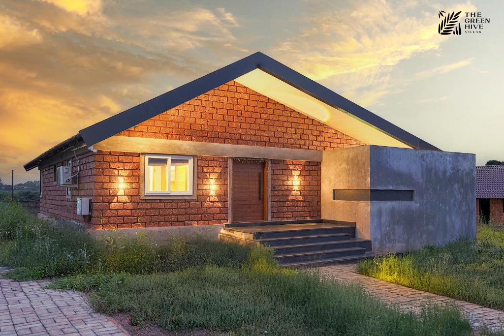 a rendering of a small house with lights on at The Green Hive Villas in Belgaum