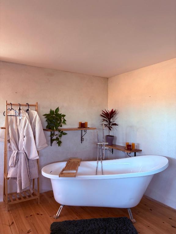a white bath tub in a bathroom with at מים במדבר in Zuqim