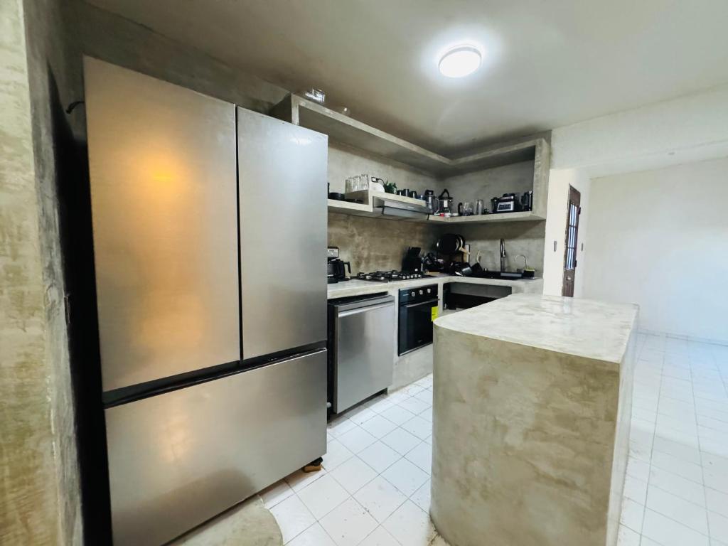 a kitchen with a large stainless steel refrigerator at Casa Baja, with Gym & Terraces in La Paz