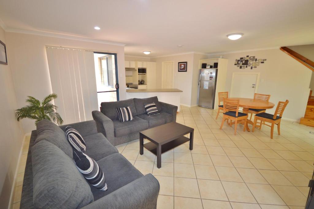 a living room with a couch and a table at Blue Ocean Villa 7 - Kalbarri, WA in Kalbarri