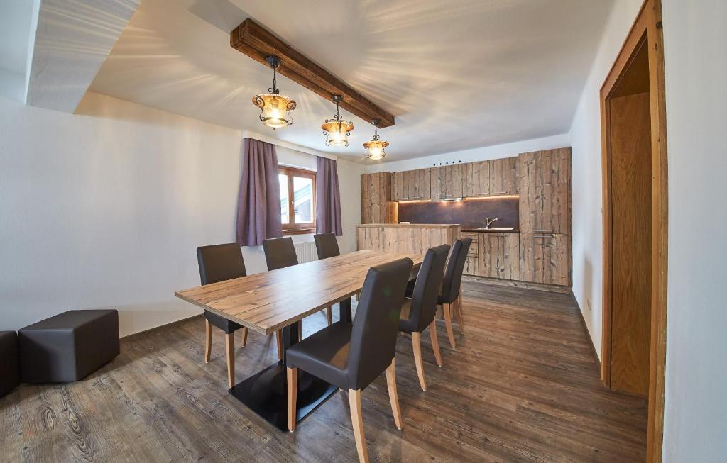 a dining room with a wooden table and chairs at Holiday Lodge Fabian in Saalbach Hinterglemm
