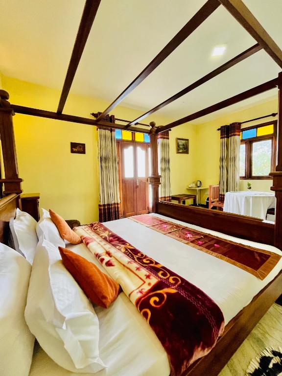 a large bedroom with a large bed with pillows at Zentara Hills in Haputale